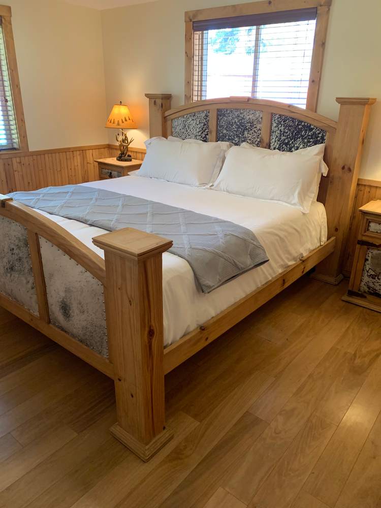 Queen bedroom with timber bed frame and window light