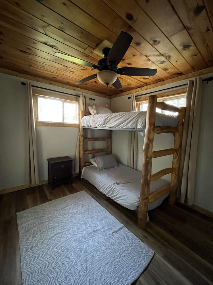 Second bedroom with twin bunk bed and wood ceiling