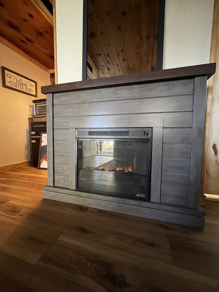 Cabin fireplace with a lit electric insert
