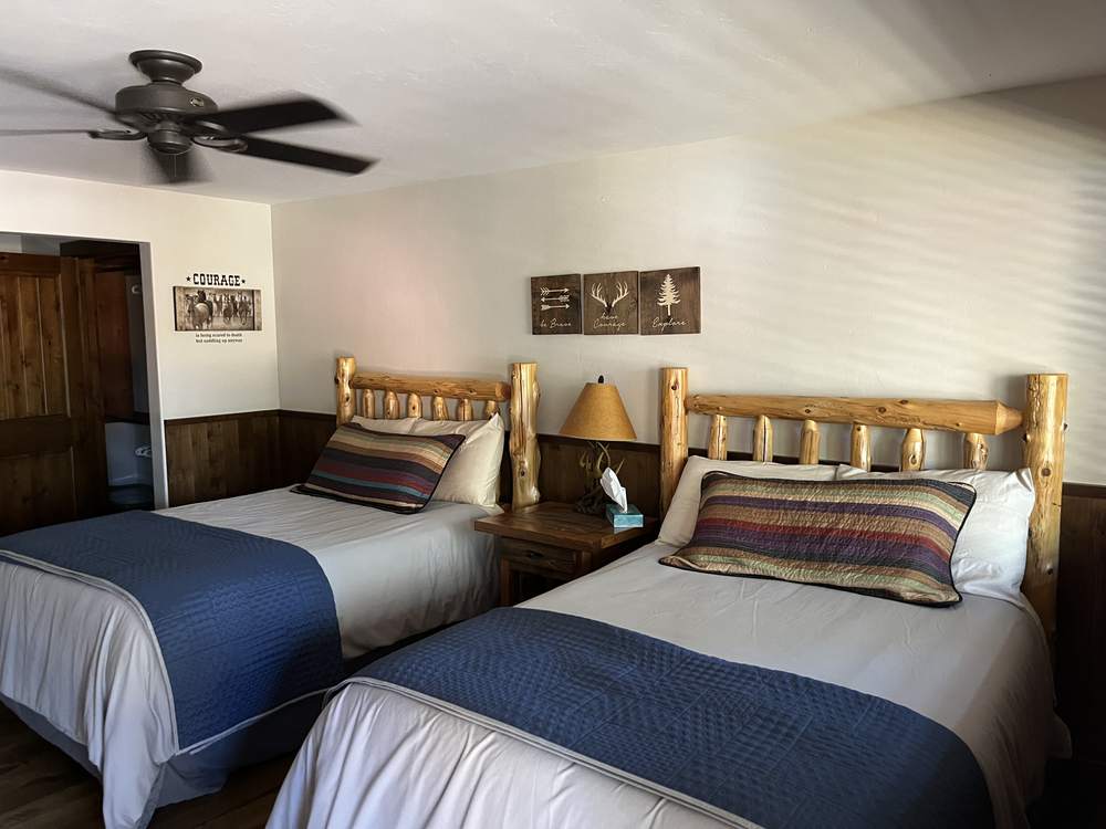 Both queen beds seen from the suite doorway