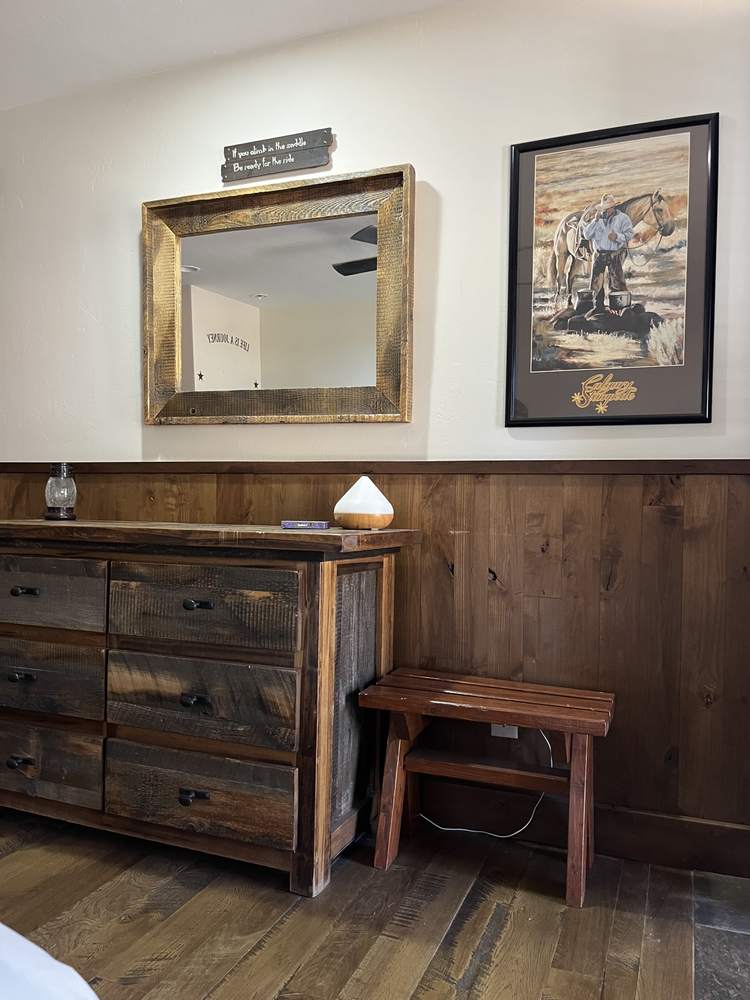 Rustic dresser with mirror and framed cowboy artwork
